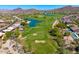 Aerial view of a golf community with lush green fairways, a scenic pond, and beautiful homes at 3601 N Sonoran Hts, Mesa, AZ 85207