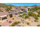 Private backyard features a putting green, lush landscaping, covered patio, and fencing at 3601 N Sonoran Hts, Mesa, AZ 85207