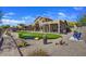 Backyard with putting green, gravel landscaping, and desert vegetation surrounding a two-story home at 3601 N Sonoran Hts, Mesa, AZ 85207