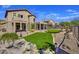 Spacious backyard with putting green, gravel landscaping, and covered patio of a two-story home at 3601 N Sonoran Hts, Mesa, AZ 85207