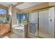 Bright bathroom with a soaking tub, large window, and glass enclosed shower at 3601 N Sonoran Hts, Mesa, AZ 85207