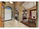 Inviting foyer with arched entryway, white door, tile flooring and dining area at 3601 N Sonoran Hts, Mesa, AZ 85207