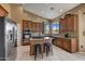 Spacious kitchen featuring stainless steel appliances, granite countertops, and an island with seating at 3601 N Sonoran Hts, Mesa, AZ 85207
