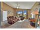 Inviting living room with a ceiling fan and beautiful views of the outdoor landscape at 3601 N Sonoran Hts, Mesa, AZ 85207