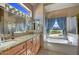 Well-lit bathroom featuring dual sinks, a soaking tub, and a separate shower at 3601 N Sonoran Hts, Mesa, AZ 85207