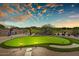 Backyard putting green with gravel landscaping, cacti and desert vegetation set against a sunset at 3601 N Sonoran Hts, Mesa, AZ 85207