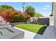 Backyard view featuring a putting green and manicured garden beds at 3710 E Hazelwood St, Phoenix, AZ 85018