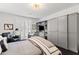 Comfortable bedroom with custom built-ins, desk, and plush bed, offering a relaxing retreat at 3710 E Hazelwood St, Phoenix, AZ 85018