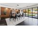 Open dining room features dark tile floors, a glass table, and access to outdoor living at 3710 E Hazelwood St, Phoenix, AZ 85018