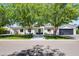 Charming single-story home with well-manicured lawn, mature trees, and modern design elements at 3710 E Hazelwood St, Phoenix, AZ 85018