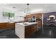 Modern kitchen with sleek cabinetry, stainless appliances, a large island, and stylish pendant lighting at 3710 E Hazelwood St, Phoenix, AZ 85018