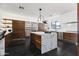Gourmet kitchen with a large island, modern lighting, stainless steel appliances, and ample counter space at 3710 E Hazelwood St, Phoenix, AZ 85018