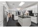 Modern kitchen featuring white cabinets, black countertops, stainless steel appliances, and an island with bar seating at 3710 E Hazelwood St, Phoenix, AZ 85018