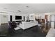 Bright open-concept living room with sleek furniture, modern design, and access to the kitchen at 3710 E Hazelwood St, Phoenix, AZ 85018