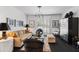 Bright living room showcasing a neutral sofa, unique lighting fixture, shuttered windows, and stylish decor at 3710 E Hazelwood St, Phoenix, AZ 85018