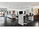Open living space with island seating, sleek furniture, and a seamless transition to outdoor living at 3710 E Hazelwood St, Phoenix, AZ 85018