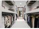 Spacious walk-in closet with ample storage and a full-length mirror at the end at 3710 E Hazelwood St, Phoenix, AZ 85018