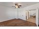 Bedroom with ceiling fan, white walls, brown carpet and open doorway at 3900 S Velero St, Chandler, AZ 85249