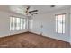 Bright and spacious bedroom with plush carpeting, multiple windows, and a large ceiling fan at 3900 S Velero St, Chandler, AZ 85249