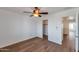Light bedroom with wood floors, ceiling fan, and easy access to closet and bathroom at 3900 S Velero St, Chandler, AZ 85249