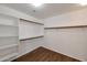 Walk-in closet featuring custom built in shelving and vinyl plank flooring at 3900 S Velero St, Chandler, AZ 85249