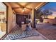 Cozy covered patio with dining furniture, ceiling fan, and view of the landscaped backyard at 3900 S Velero St, Chandler, AZ 85249