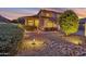 Beautifully illuminated home exterior with a neatly landscaped yard and a welcoming desert garden at sunset at 3900 S Velero St, Chandler, AZ 85249