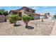 Well-maintained home featuring low-maintenance desert landscaping, mature trees, and a spacious driveway at 3900 S Velero St, Chandler, AZ 85249
