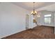 Open and airy living area with large windows, tiled flooring, and a bright chandelier, creating a welcoming ambiance at 3900 S Velero St, Chandler, AZ 85249