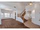 Inviting interior view showcasing a staircase with wood railings, tiled flooring, and a spacious living area at 3900 S Velero St, Chandler, AZ 85249