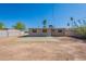 View of the backyard with block fencing and mature landscaping at 3946 W Monte Vista Rd, Phoenix, AZ 85009