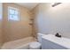 Cozy bathroom featuring a shower-tub combo and tiled walls at 3946 W Monte Vista Rd, Phoenix, AZ 85009