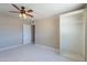 Bright bedroom with ceiling fan, built in closet and white tile flooring at 3946 W Monte Vista Rd, Phoenix, AZ 85009