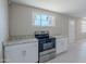 Bright kitchen featuring modern appliances, a stylish range oven, and tiled flooring at 3946 W Monte Vista Rd, Phoenix, AZ 85009