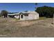 Side view of the home's exterior, revealing neutral siding and a compact yard at 3948 E Monterosa St, Phoenix, AZ 85018