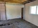 Partially renovated room featuring exposed brick, unfinished walls, and a concrete floor at 3948 E Monterosa St, Phoenix, AZ 85018