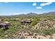 Stunning aerial view showcasing the property surrounded by lush desert vegetation and distant mountain peaks on a clear day at 40215 N 110Th Pl, Scottsdale, AZ 85262