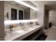 Bathroom features a long marble countertop with multiple sinks, providing ample space and a clean, modern aesthetic at 40215 N 110Th Pl, Scottsdale, AZ 85262
