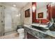Modern bathroom features a unique sink basin, wood trimmed mirrors and a glass shower enclosure at 40215 N 110Th Pl, Scottsdale, AZ 85262