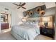 Comfortable primary bedroom with neutral decor, ensuite bath, and a decorative wall feature at 40215 N 110Th Pl, Scottsdale, AZ 85262