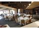 Elegant dining area features round tables with white linens and sophisticated seating in a bright, spacious room at 40215 N 110Th Pl, Scottsdale, AZ 85262