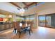 Bright dining area featuring a wood table, upholstered chairs, modern lighting, and beautiful views through large windows at 40215 N 110Th Pl, Scottsdale, AZ 85262
