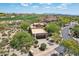 View of home showing desert landscaping, driveway, and golf course view at 40215 N 110Th Pl, Scottsdale, AZ 85262