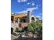 Stunning stone and stucco exterior with a covered patio and lush landscaping create an inviting curb appeal at 40215 N 110Th Pl, Scottsdale, AZ 85262