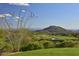 Picturesque view of golf course featuring desert landscape and mountain views at 40215 N 110Th Pl, Scottsdale, AZ 85262