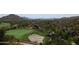 A pristine green golf course with a sand trap is nestled in the desert landscape at 40215 N 110Th Pl, Scottsdale, AZ 85262
