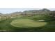 Lush golf course green with mountain views provides a scenic backdrop for recreational enjoyment at 40215 N 110Th Pl, Scottsdale, AZ 85262