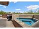 Relaxing hot tub on a patio with scenic desert views under a blue sky, perfect for outdoor enjoyment at 40215 N 110Th Pl, Scottsdale, AZ 85262