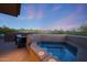 Relax in this outdoor hot tub with a scenic backdrop of desert landscape and a beautiful evening sky at 40215 N 110Th Pl, Scottsdale, AZ 85262