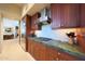 Gourmet kitchen with custom wood cabinets, granite countertops, and high-end stainless steel appliances at 40215 N 110Th Pl, Scottsdale, AZ 85262